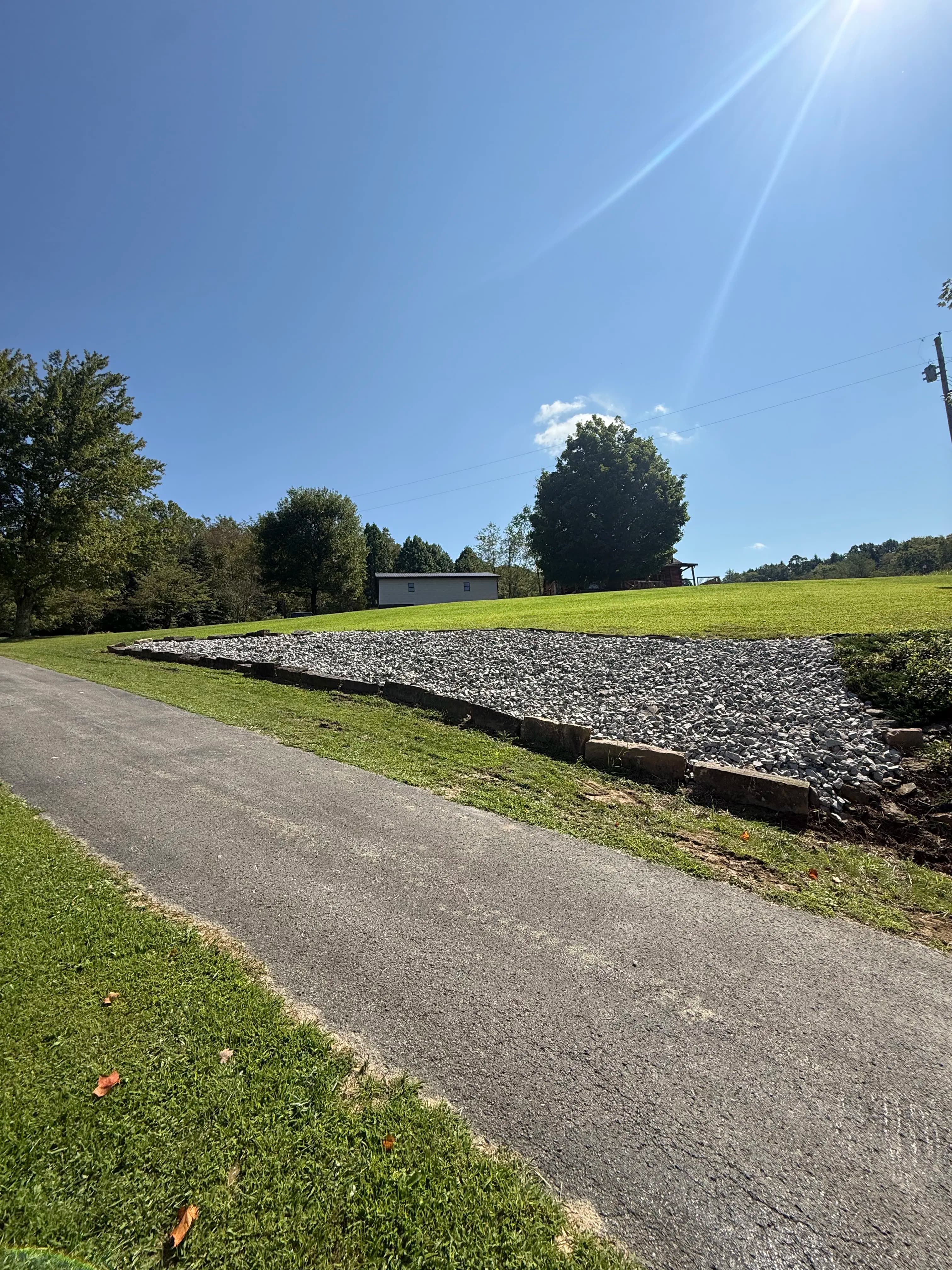 Project Stone Coverage on a Sloped Hillside That Never Stops Growing image